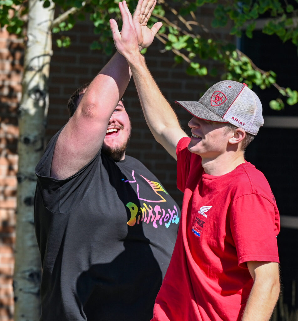 Photo of students giving a high five.