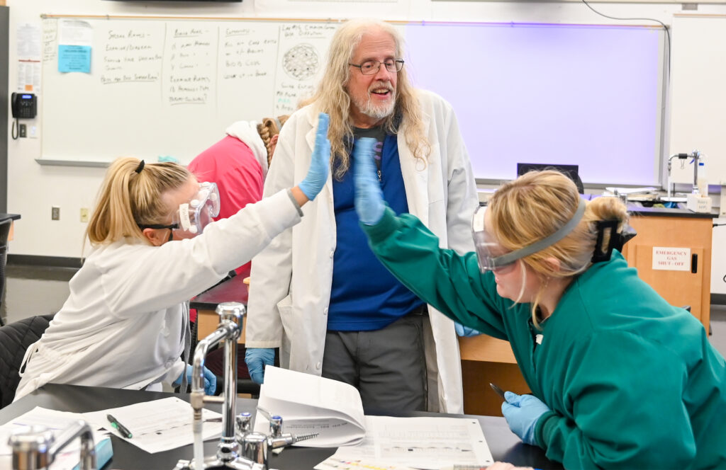 Photo of students and instructor in a lab classroom.